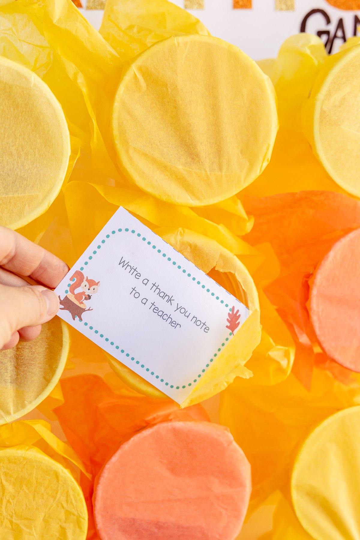 woman's hand pulling a gratitude activity out of a cup