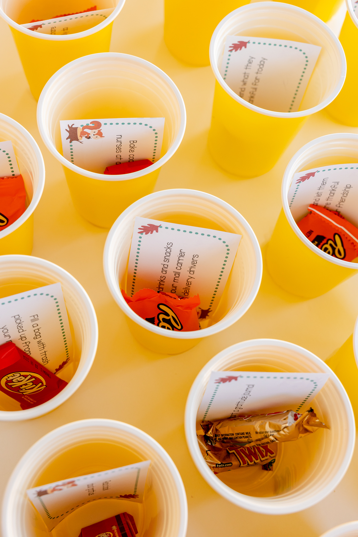plastic cups filled with treats and gratitude activities in a gratitude game