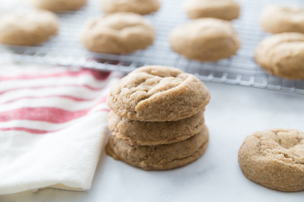 A stack of chewy molasses cookies showing how thick and fluffy they are