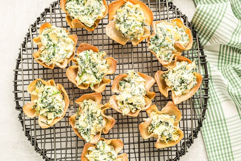 Filled spinach artichoke cups on a tray