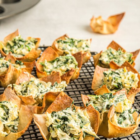 A cooling rack full of spinach dip cups