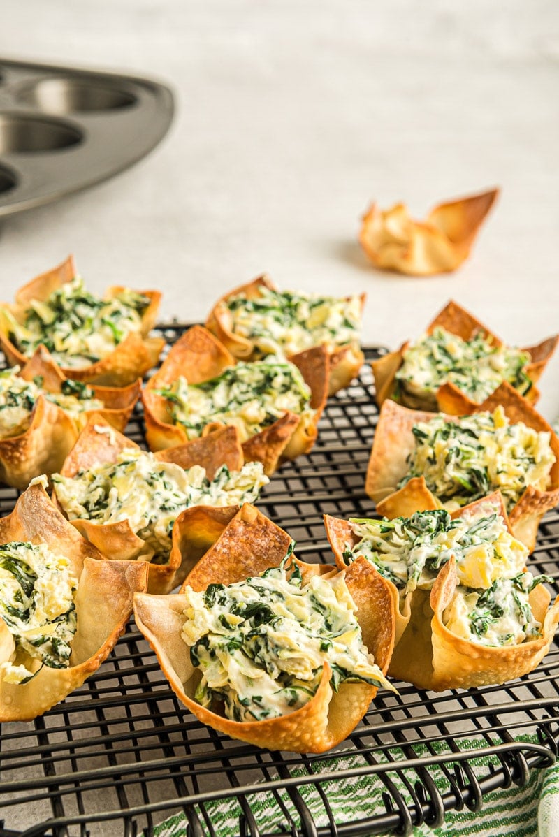 A cooling rack full of spinach dip cups