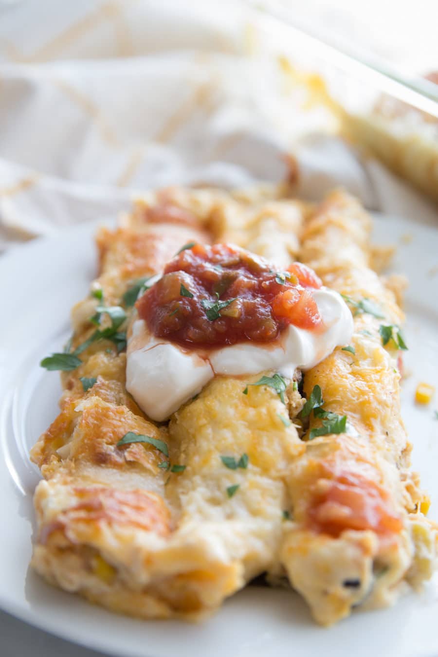 A plate full of white chicken enchiladas