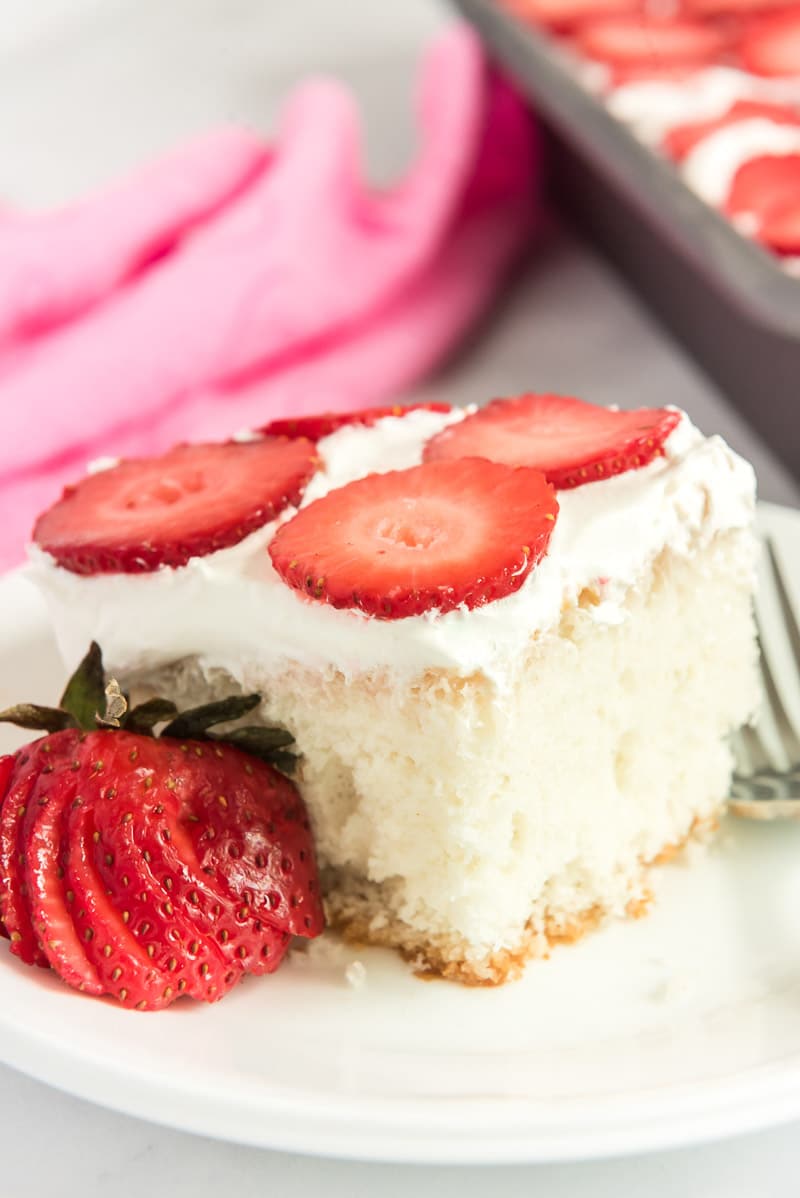 A square piece of strawberry poke cake