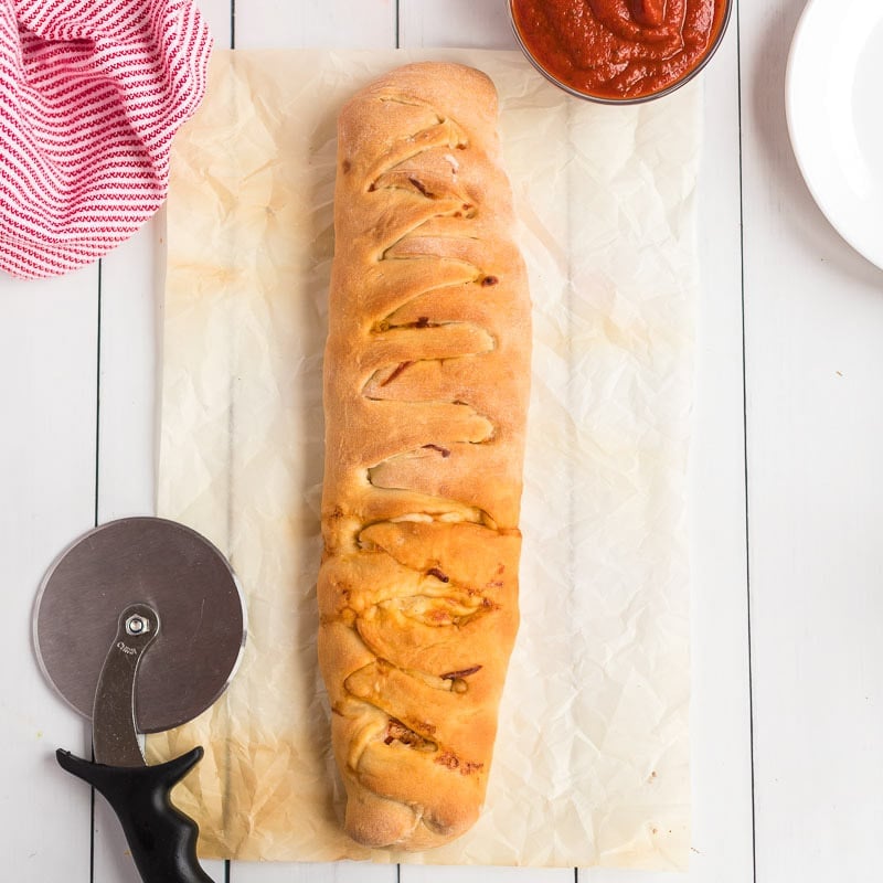 Baked pizza loaf ready to be cut