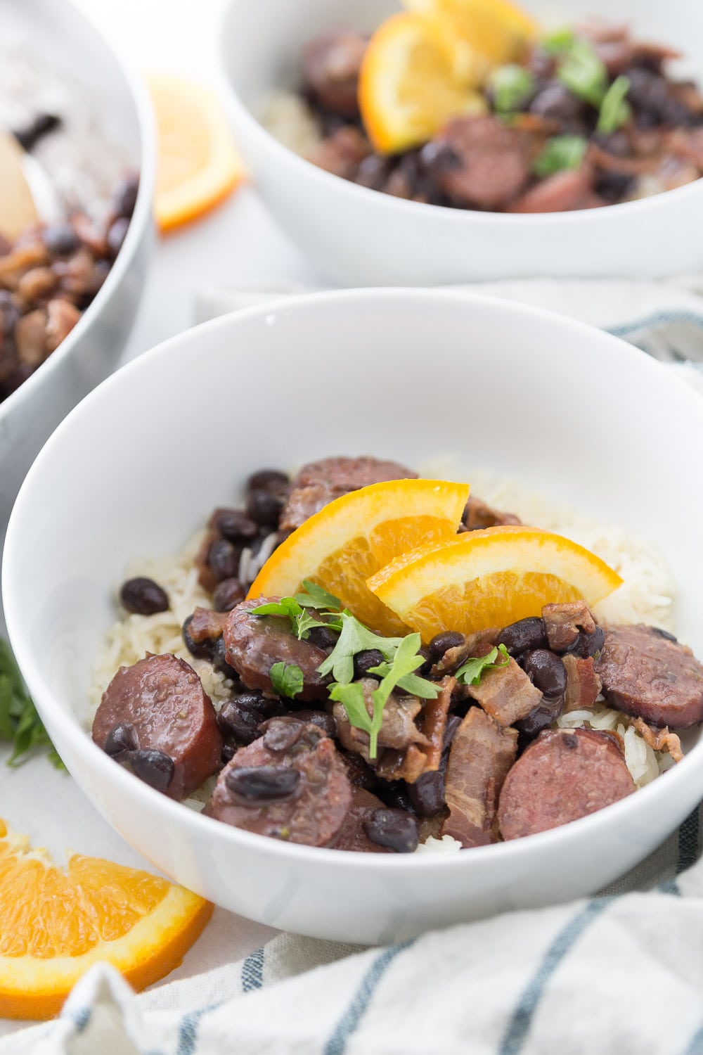 Bowl of feijoada with oranges