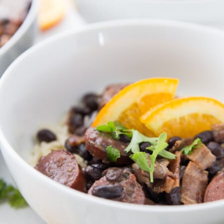 Bowl of feijoada with oranges