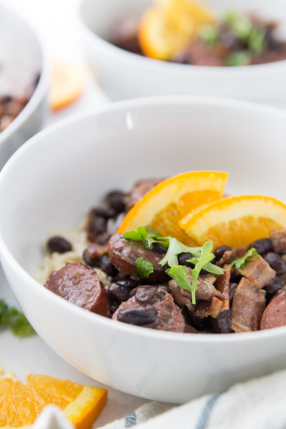 Bowl of feijoada with oranges