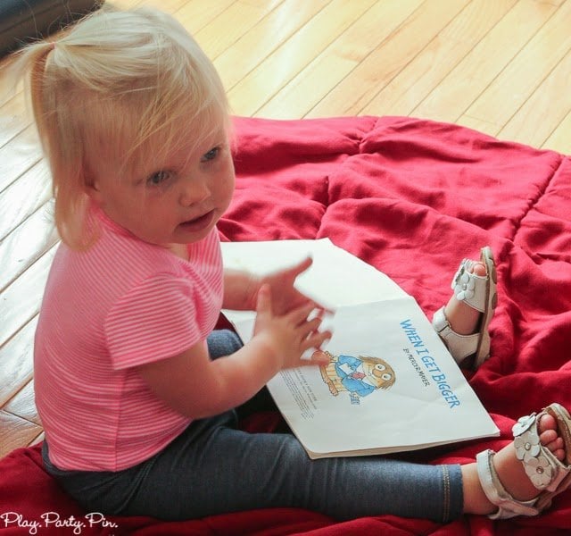 toddler looking through a book