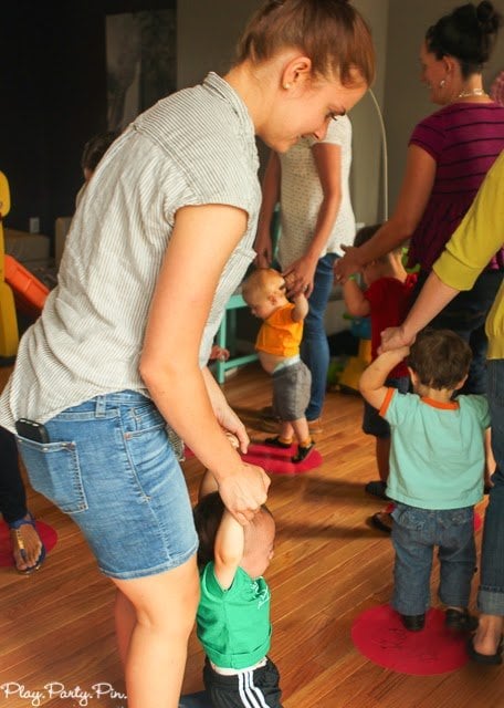 moms with their kids doing the apple walk game
