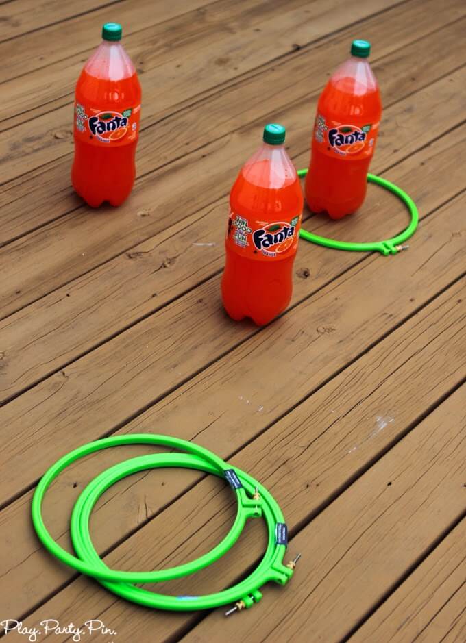 Two-liter ring toss using orange Fanta bottles for fun Halloween party game