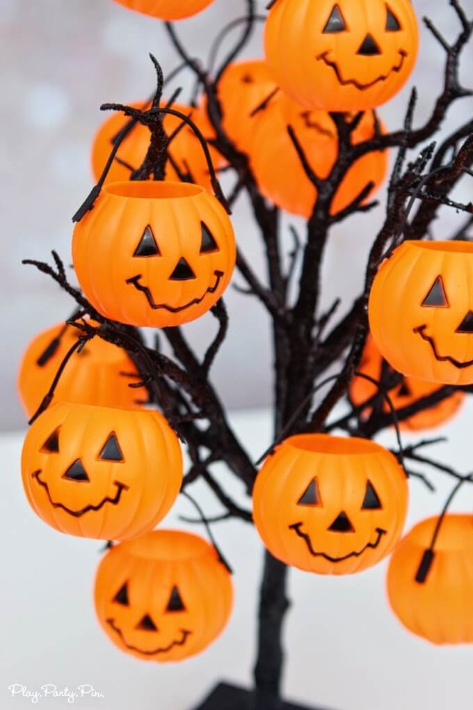 Kids will love this Halloween party game idea where they pick a pumpkin with a trick or treat inside 