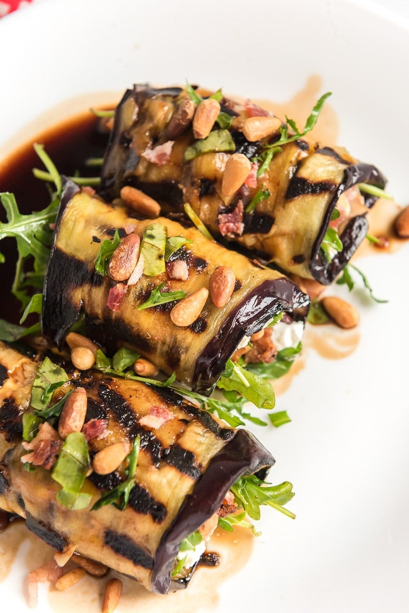 Eggplant rolls with pine nuts and bacon on top