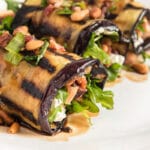 Eggplant rolls topped with pine nuts and goat cheese