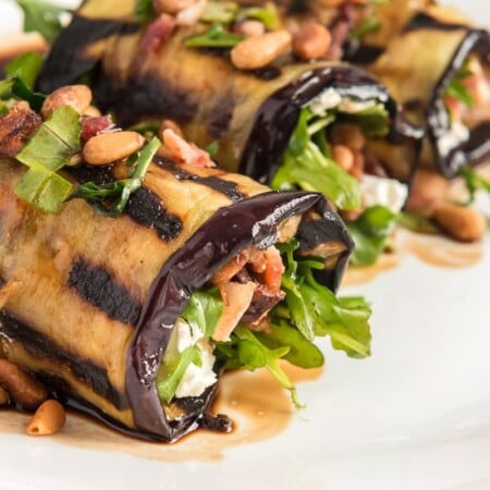 Eggplant rolls topped with pine nuts and goat cheese