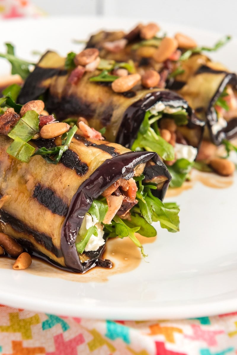 Eggplant rolls topped with pine nuts and goat cheese