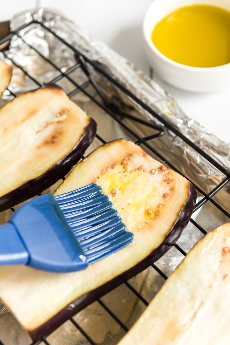 brushing eggplant slices with olive oil