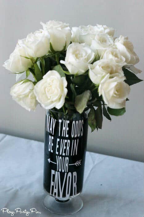 Hunger Games vase with white roses, perfect for a Hunger Games party