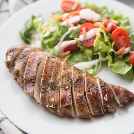 Piece of sliced balsamic chicken with salad