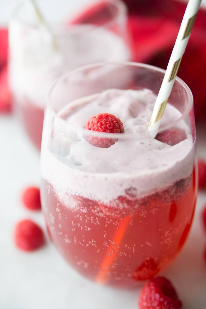 A glass of non alcoholic holiday punch with a straw