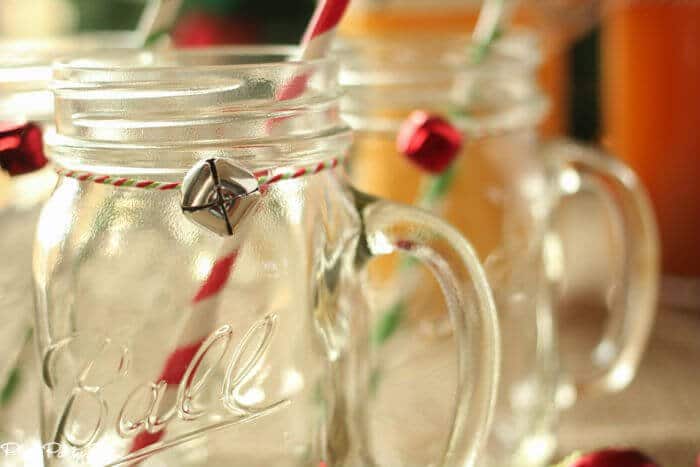 Mason jar mugs tied with baking twine and a little jingle bell, perfect for holiday drinks