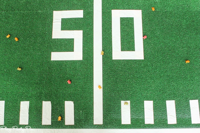 Fun Super Bowl party games like this one where you have guests try to toss things to get them to land on football field lines! 