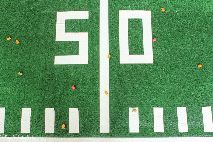 Fun Super Bowl party games like this one where you have guests try to toss things to get them to land on football field lines!