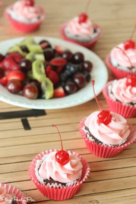 Cherry coke cupcakes topped with a cherry buttercream frosting