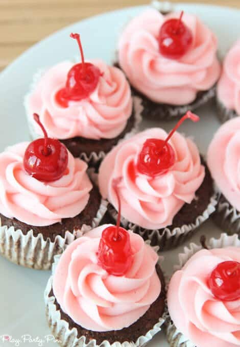 Cherry coke cupcakes topped with a cherry buttercream frosting