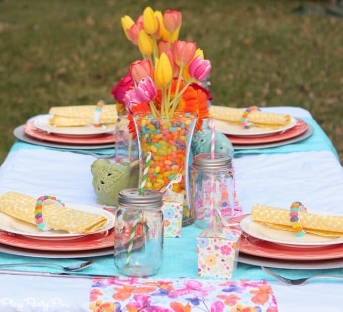 Gorgeous spring tablescape ideas, love the fabrics and jelly bean vases and napkin rings