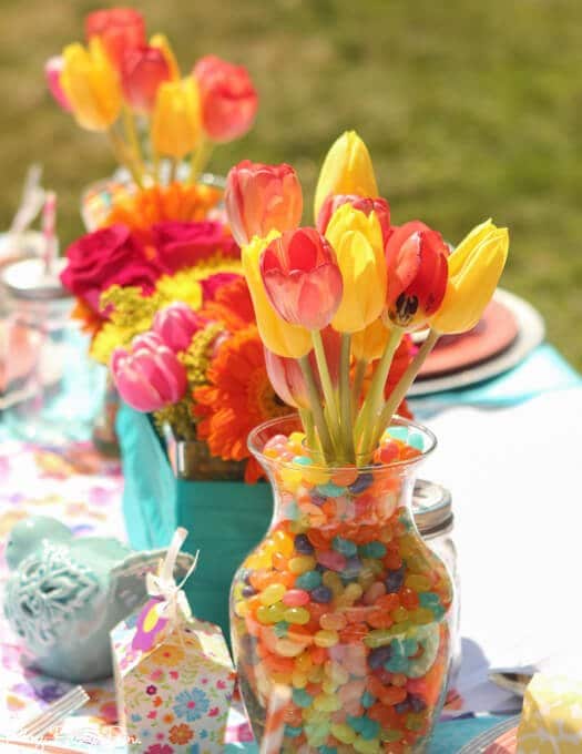 Gorgeous spring tablescape ideas, love the fabrics and jelly bean vases and napkin rings