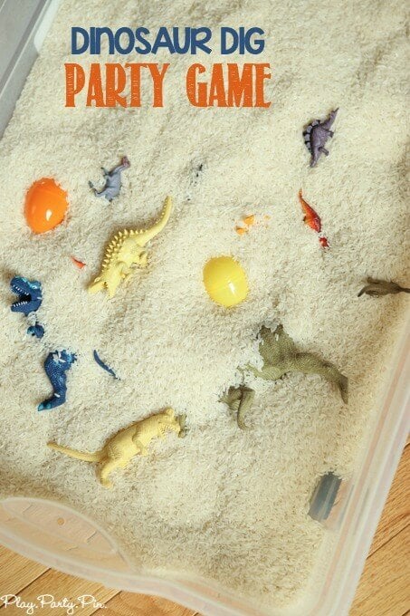 Dinosaur games using rice or sand, plastic eggs, and plastic dinosaur toys