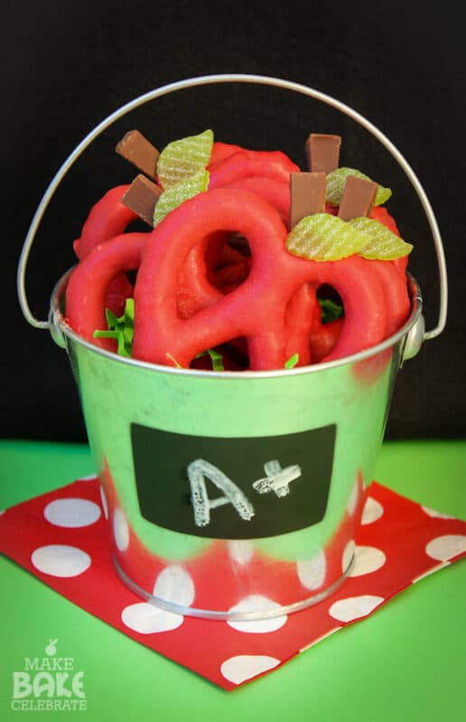 Red pretzels in a green bucket with an A+ sign