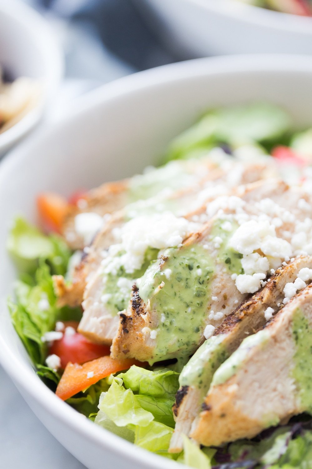 A bowl with southwestern chicken salad and dressing