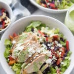 Two bowls of southwestern chicken salad with dressing