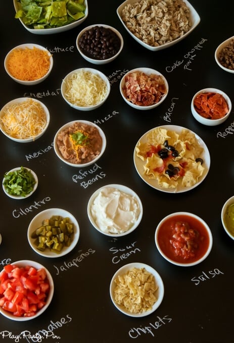 Love this DIY nacho bar with free printables for a football party, how fun are those football playbook printables?