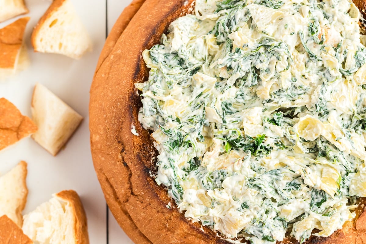 spinach and artichoke dip in a bread bowl