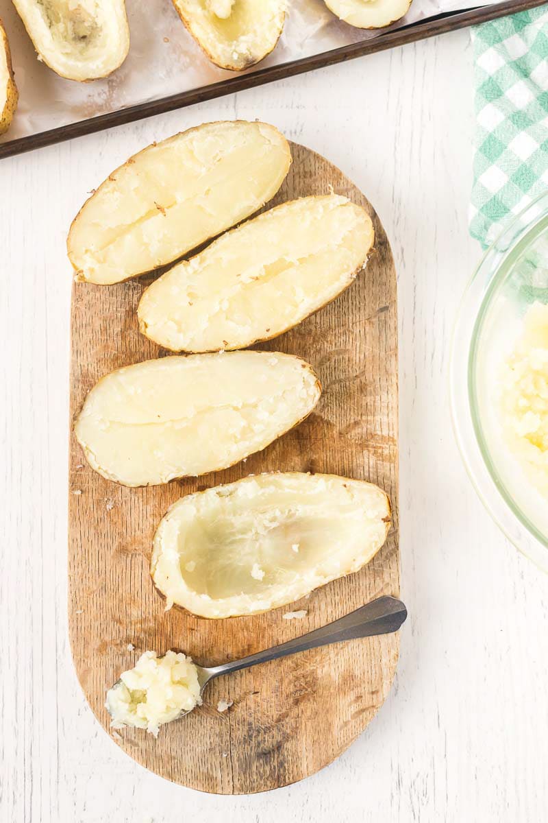 Scooping out insides of boursin cheese potatoes