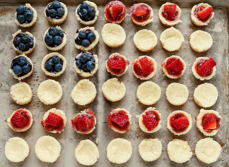 This red, white, and blue mini cheesecake recipe is the perfect 4th of July dessert or Memorial Day treat, a protein packed crust topped with a sweet cream cheese topping. 