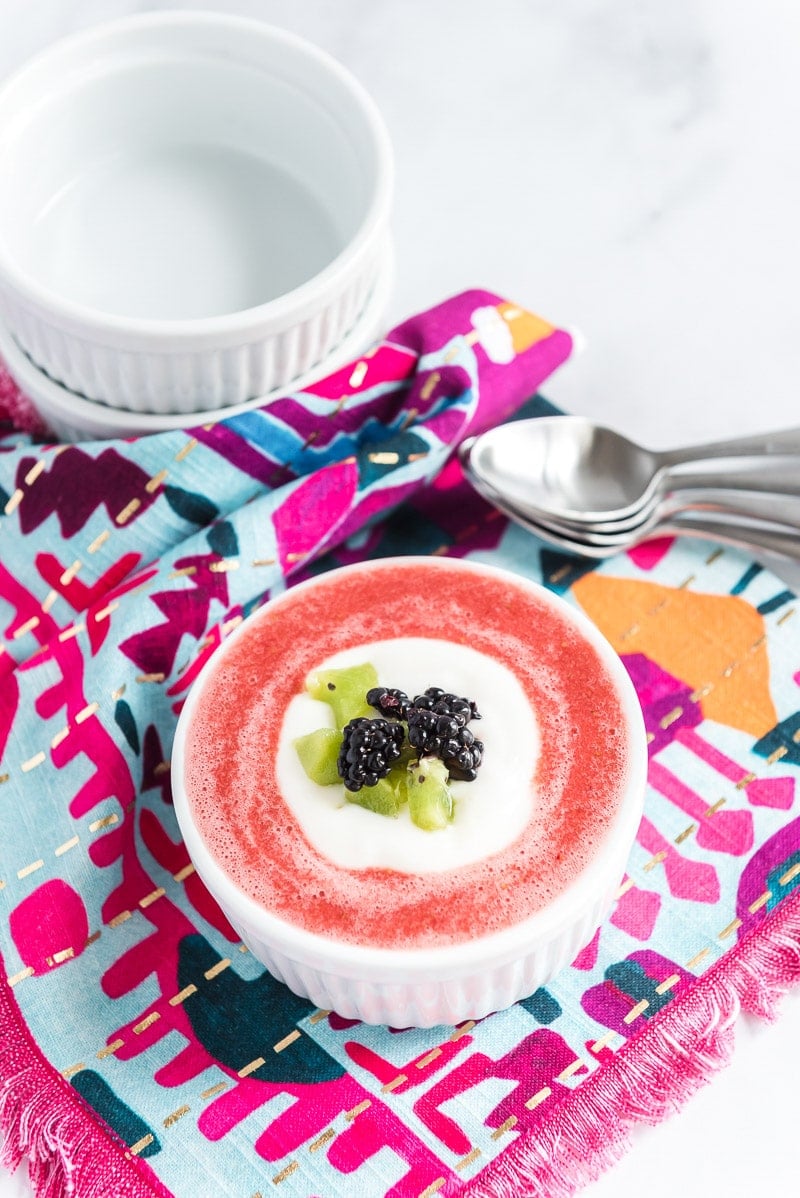 Bowl of strawberry soup with fruit on top