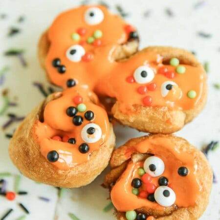 These monster inspired mini cinnamon rolls are the perfect monster food for Halloween! Start with Pillsbury crescents and turn them into something that both kids and adults will love. They’re great for a party, for Halloween breakfast, or when you want something homemade but don’t have time to make cinnamon rolls from scratch. I love the fun little surprises inside.