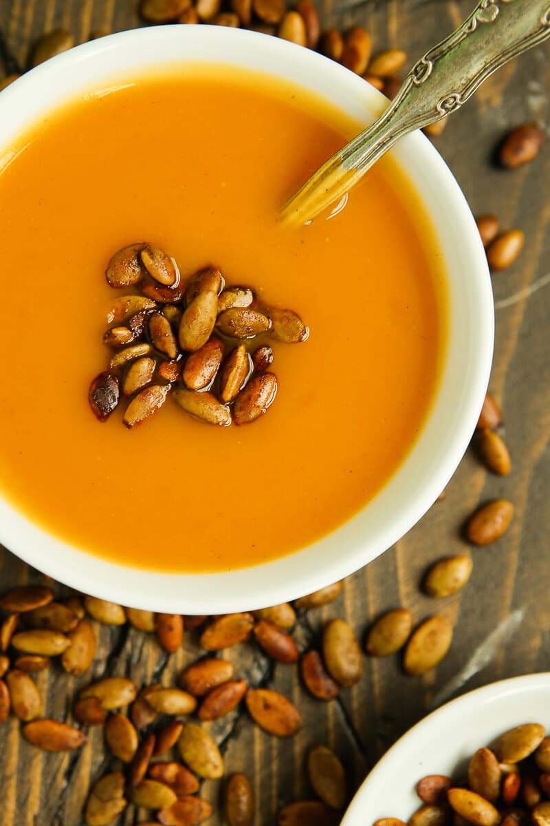 This easy butternut squash soup is like a healthy comfort food! Take some roasted butternut squash, mix it with broth in your Vitamix or other blender, and finish it off with some spicy pepitas. It’s creamy, dairy free, and one of the best butternut squash recipes I’ve tried!