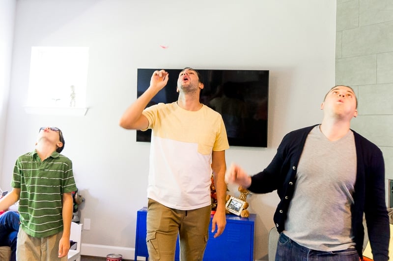 Boys blowing feathers in some Thanksgiving family games