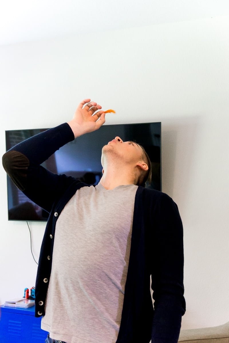 A man keeping a feather up for some fun Thanksgiving games