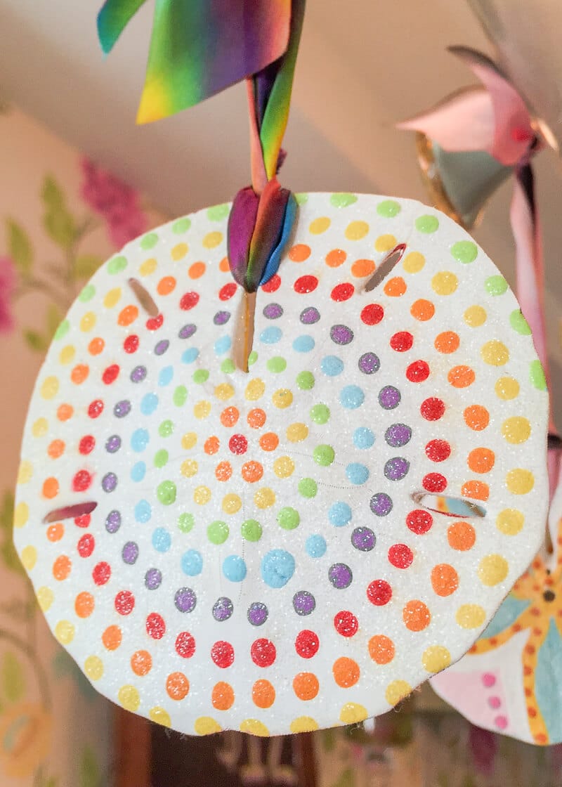 painted Sand Dollar hanging from a branch