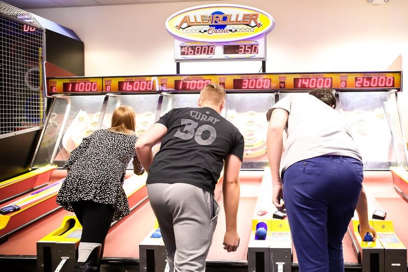 Playing skeeball at a Chuck E Cheese birthday party