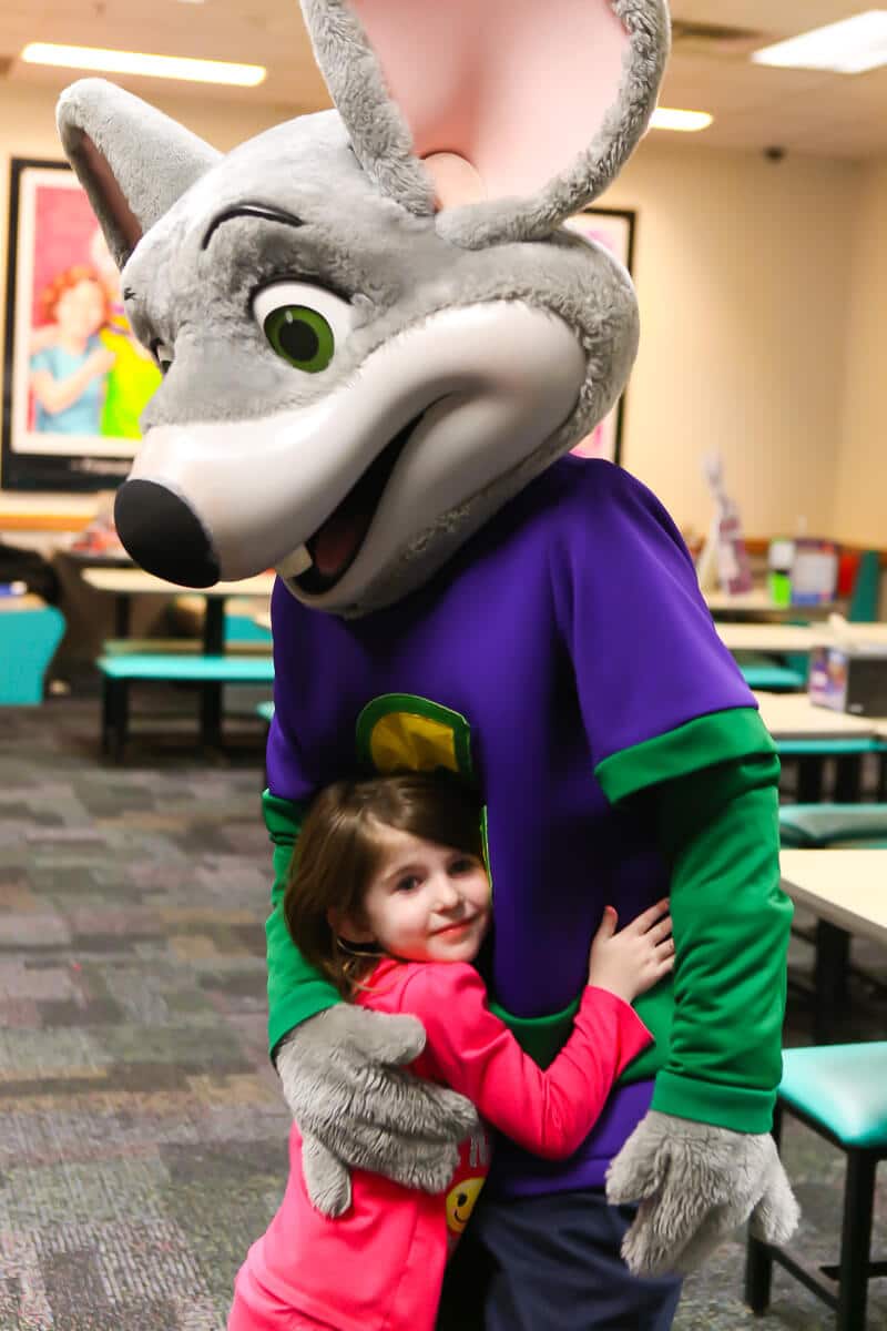 Hugging Chuck E Cheese at a Chuck E Cheese party