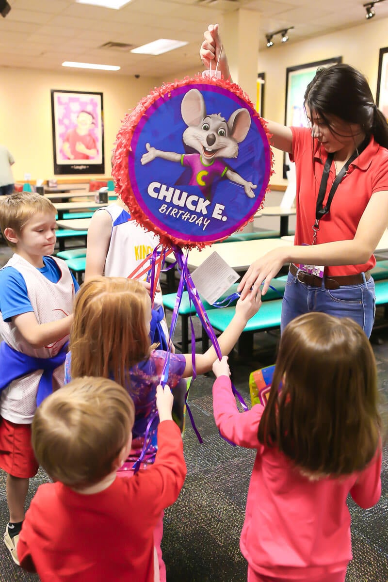 Pulling the strings on a Chuck E Cheese birthday pinata