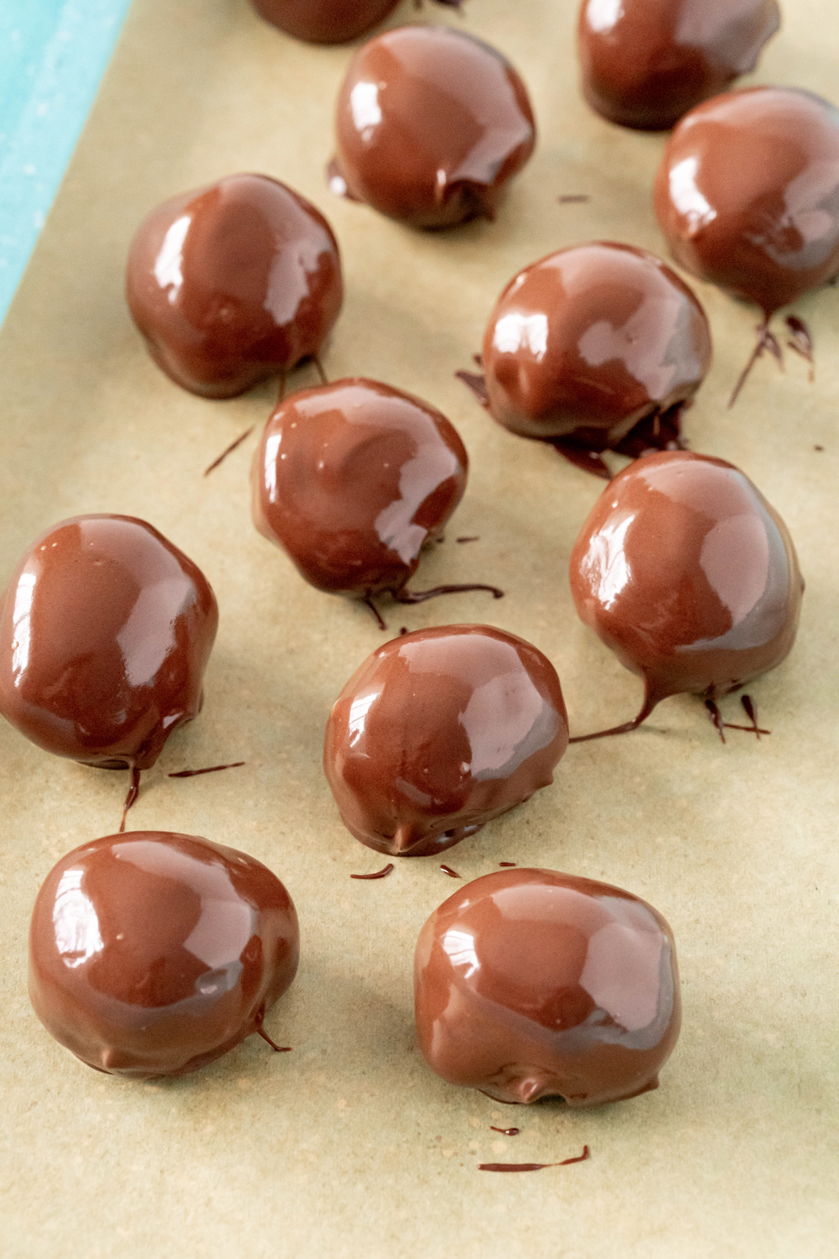 chocolate dipped chocolate truffles on a piece of parchment ppaer