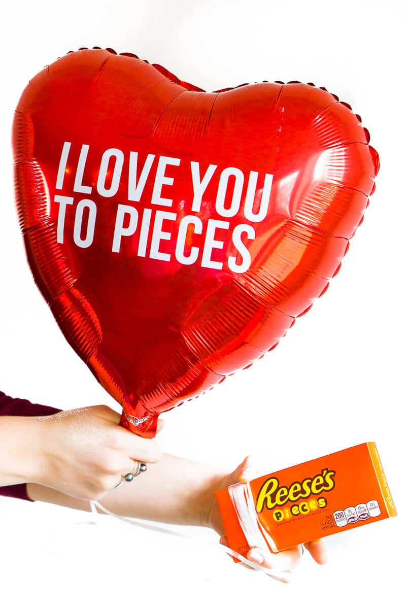 Forget traditional candy grams! This year for Valentine's Day, kick old-school candy grams up a notch with this fun DIY balloon candy gram idea! With tons of clever candy bar sayings and simple instructions, this makes the best gift for boyfriend or any valentine! Love the list of other Valentine's Day gifts for him at the bottom too!